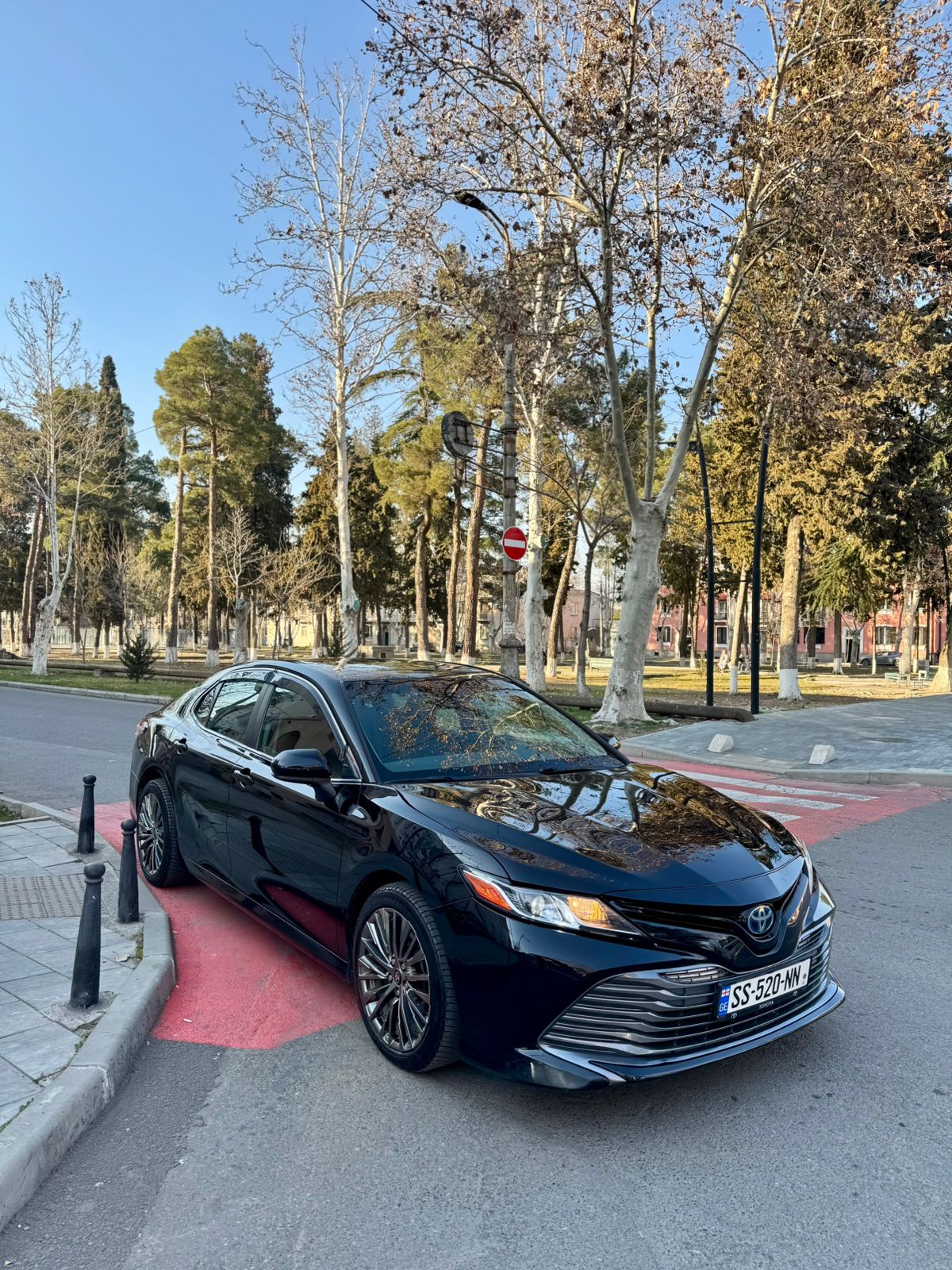 Toyota Camry 2024 front-side view available for rent in Tbilisi, Georgia.